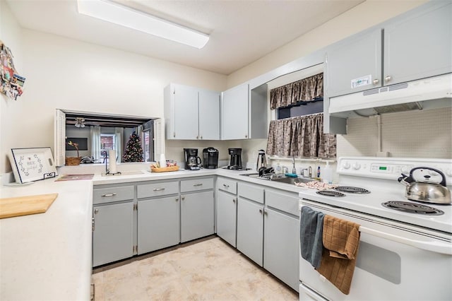 4748 Azalea Dr Unit 204, New Port Richey, FL 34652 - kitchen with white electric range oven, under cabinet range hood, light countertops, and a sink