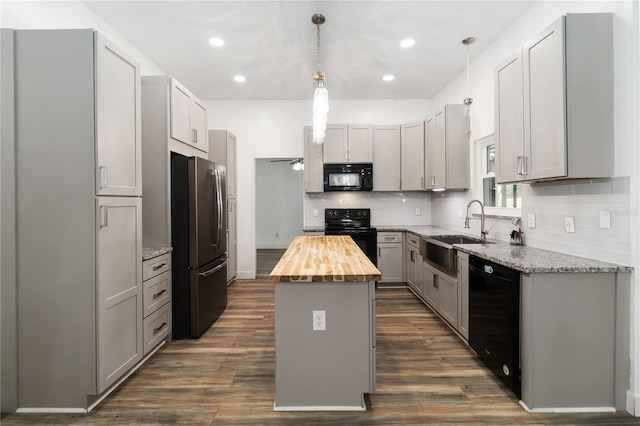 722 Swaying Palm Dr, Apopka, FL 32712 - kitchen featuring black appliances, butcher block counters, a center island, decorative backsplash, and recessed lighting