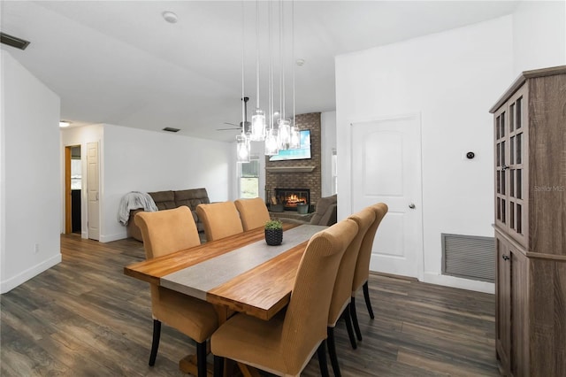 722 Swaying Palm Dr, Apopka, FL 32712 - dining room with a fireplace, dark wood-style floors, and a ceiling fan