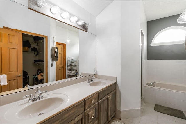 722 Swaying Palm Dr, Apopka, FL 32712 - full bath featuring tile patterned floors, a bath, double vanity, and a walk in closet