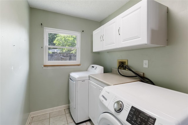 722 Swaying Palm Dr, Apopka, FL 32712 - washroom with cabinet space, separate washer and dryer, light tile patterned flooring, and a textured ceiling