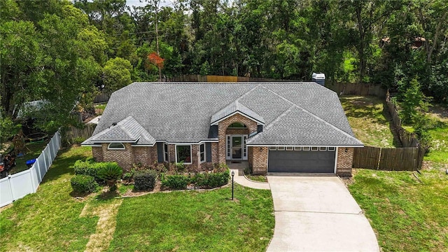722 Swaying Palm Dr, Apopka, FL 32712 - view of front facade featuring an attached garage, brick siding, driveway, and a fenced backyard