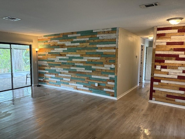 2123 Woodburn Loop S, Lakeland, FL 33813 - unfurnished room with baseboards, wood finished floors, and wood walls