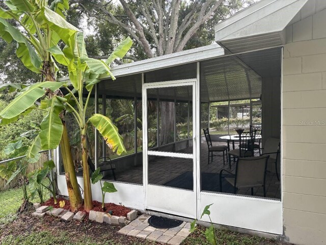 2123 Woodburn Loop S, Lakeland, FL 33813 - view of home's exterior featuring a sunroom and concrete block siding