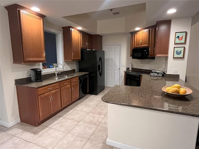 12064 Navale Ln, Orlando, FL 32827 - kitchen with black appliances, a sink, light tile patterned floors, recessed lighting, and dark stone countertops