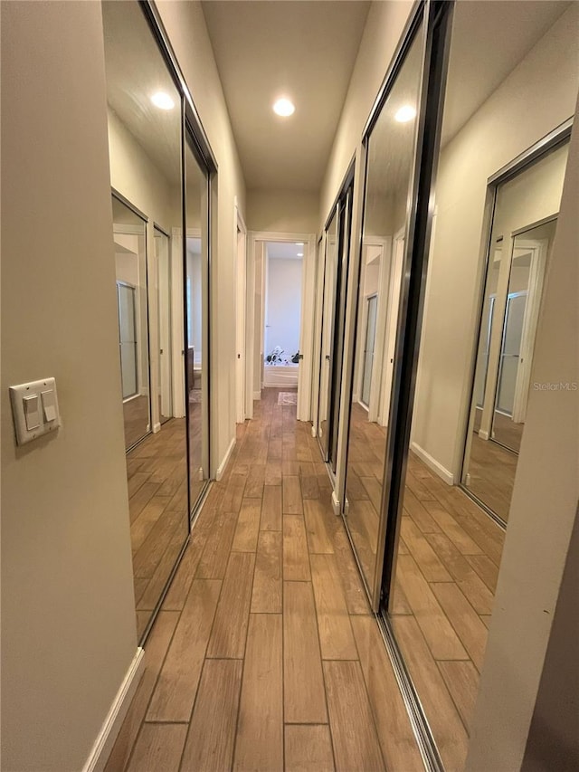 12064 Navale Ln, Orlando, FL 32827 - hallway with light wood finished floors and recessed lighting