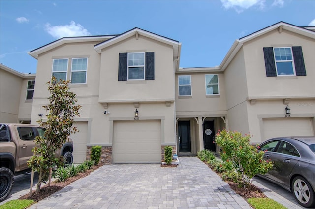 4262 Cloud Hopper Way, Lutz, FL 33559 - view of property featuring an attached garage, stucco siding, and decorative driveway