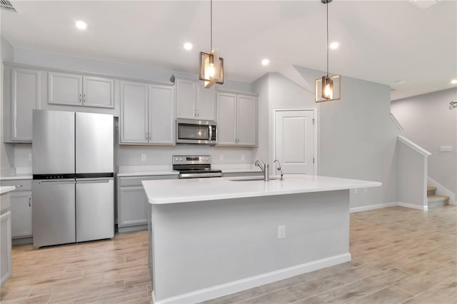 4262 Cloud Hopper Way, Lutz, FL 33559 - kitchen with appliances with stainless steel finishes, gray cabinets, light countertops, light wood-style floors, and recessed lighting