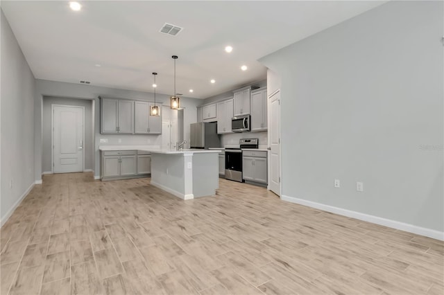 4262 Cloud Hopper Way, Lutz, FL 33559 - kitchen with appliances with stainless steel finishes, gray cabinetry, light countertops, open floor plan, and recessed lighting