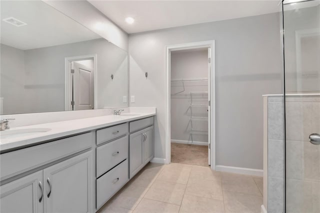 4262 Cloud Hopper Way, Lutz, FL 33559 - full bathroom with double vanity, a walk in closet, recessed lighting, and tile patterned flooring