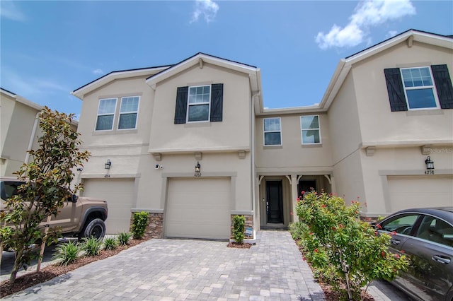 4262 Cloud Hopper Way, Lutz, FL 33559 - multi unit property featuring stucco siding, an attached garage, decorative driveway, and stone siding