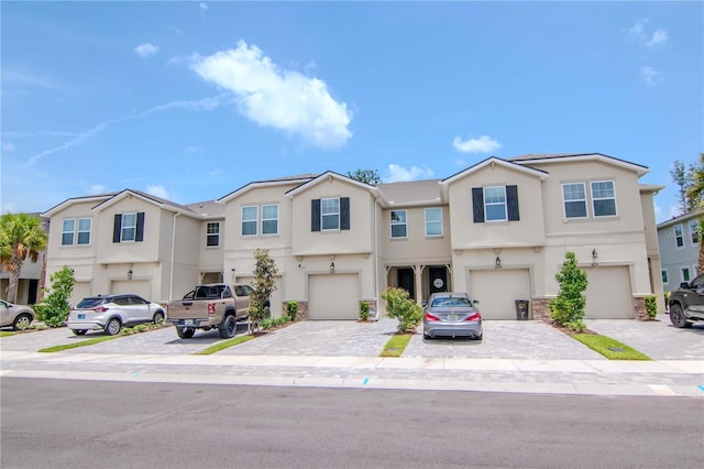 4262 Cloud Hopper Way, Lutz, FL 33559 - multi unit property featuring stucco siding, an attached garage, and driveway
