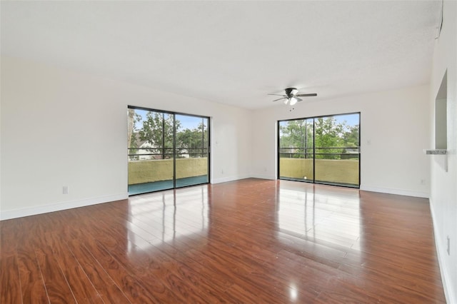 13612 S Village Dr Unit 5201, Tampa, FL 33618 - empty room featuring a ceiling fan, baseboards, and wood finished floors