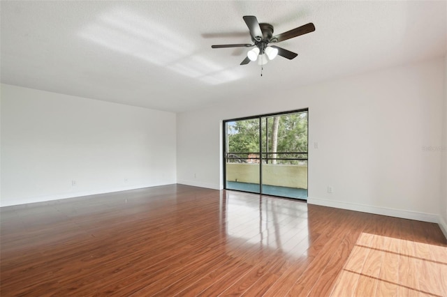 13612 S Village Dr Unit 5201, Tampa, FL 33618 - spare room featuring wood finished floors, a ceiling fan, and baseboards