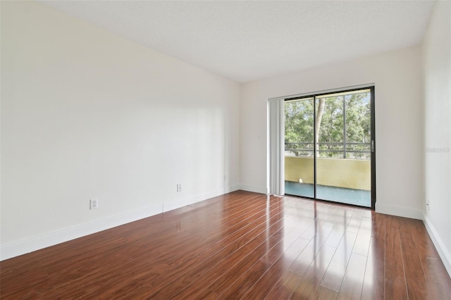 13612 S Village Dr Unit 5201, Tampa, FL 33618 - empty room with dark wood-style flooring and baseboards