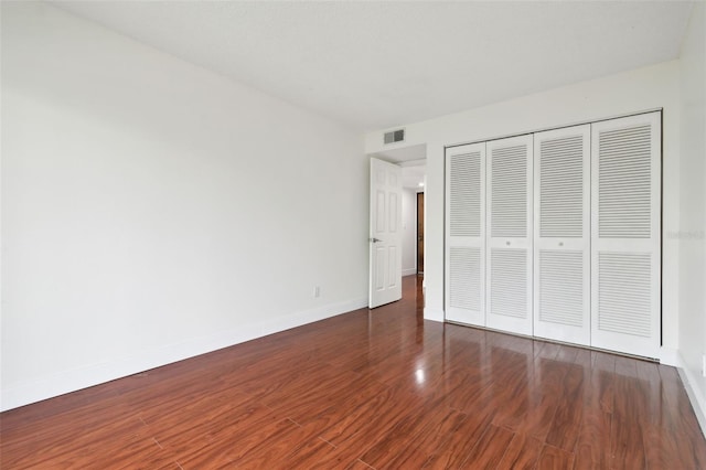 13612 S Village Dr Unit 5201, Tampa, FL 33618 - unfurnished bedroom featuring wood finished floors, a closet, and baseboards