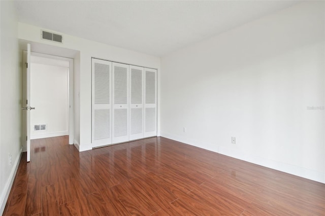 13612 S Village Dr Unit 5201, Tampa, FL 33618 - unfurnished bedroom featuring a closet, baseboards, and wood finished floors