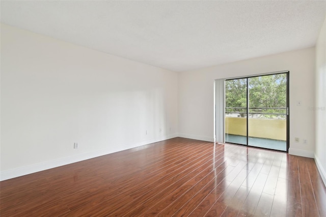 13612 S Village Dr Unit 5201, Tampa, FL 33618 - spare room with dark wood-type flooring and baseboards