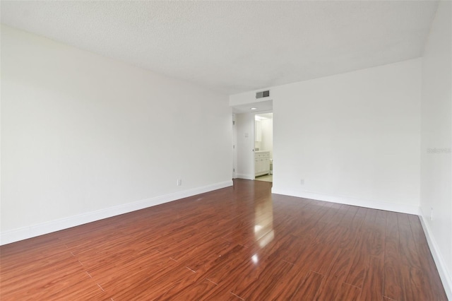 13612 S Village Dr Unit 5201, Tampa, FL 33618 - spare room with dark wood-type flooring and baseboards