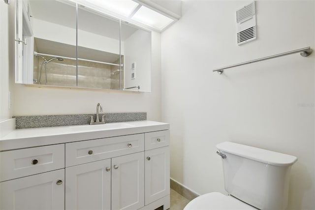 13612 S Village Dr Unit 5201, Tampa, FL 33618 - full bathroom with toilet, vanity, tiled shower, and baseboards