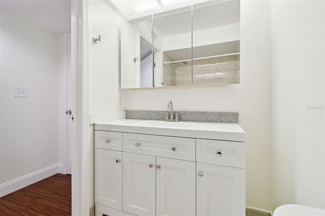 13612 S Village Dr Unit 5201, Tampa, FL 33618 - full bath featuring vanity, toilet, a shower, wood finished floors, and baseboards