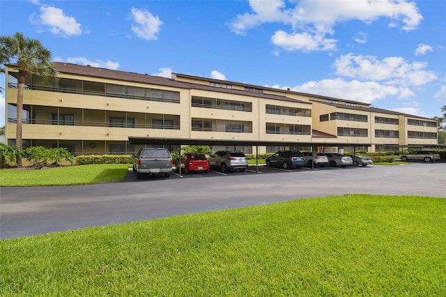 13612 S Village Dr Unit 5201, Tampa, FL 33618 - view of apartment building / complex with covered and uncovered parking
