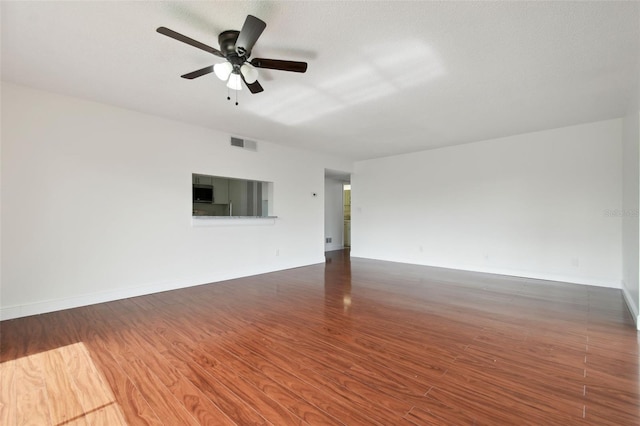 13612 S Village Dr Unit 5201, Tampa, FL 33618 - empty room with wood finished floors, a ceiling fan, and baseboards