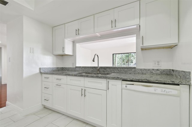13612 S Village Dr Unit 5201, Tampa, FL 33618 - kitchen with dishwasher, a sink, stone counters, white cabinets, and baseboards