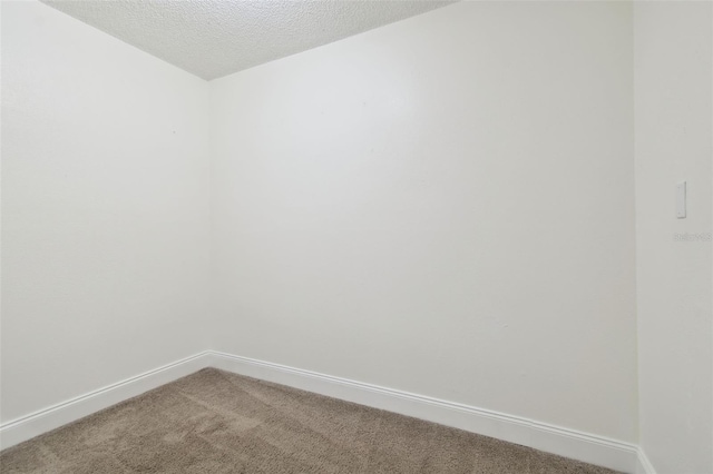 13612 S Village Dr Unit 5201, Tampa, FL 33618 - empty room with carpet floors, baseboards, and a textured ceiling