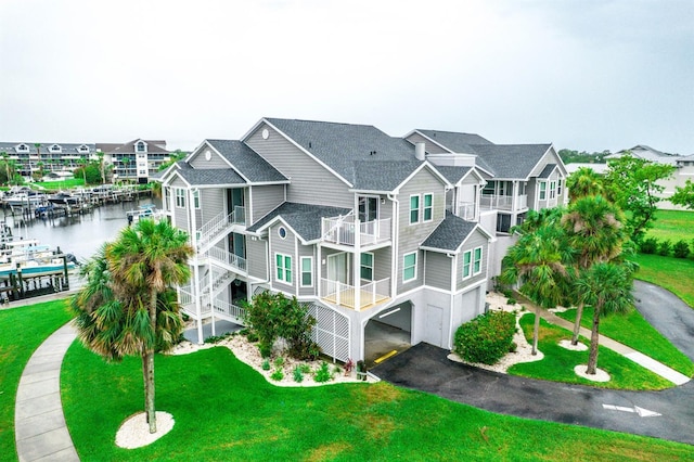5712 Biscayne Ct Unit 201, New Port Richey, FL 34652 - view of building exterior featuring a garage, asphalt driveway, and a water view