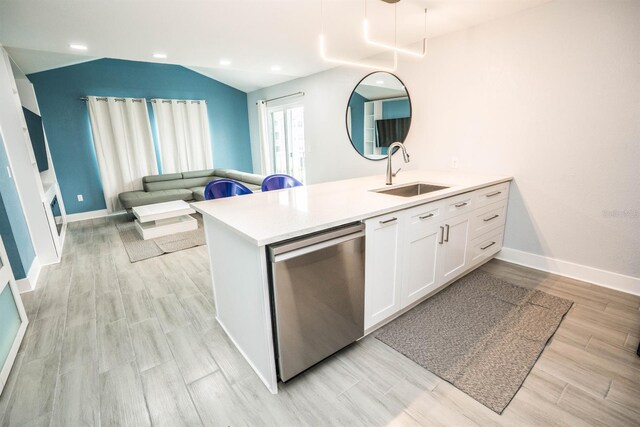 5712 Biscayne Ct Unit 201, New Port Richey, FL 34652 - kitchen featuring stainless steel dishwasher, a sink, white cabinetry, light countertops, and a peninsula