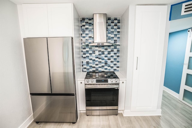 5712 Biscayne Ct Unit 201, New Port Richey, FL 34652 - kitchen with stainless steel appliances, wall chimney exhaust hood, light wood finished floors, and tasteful backsplash