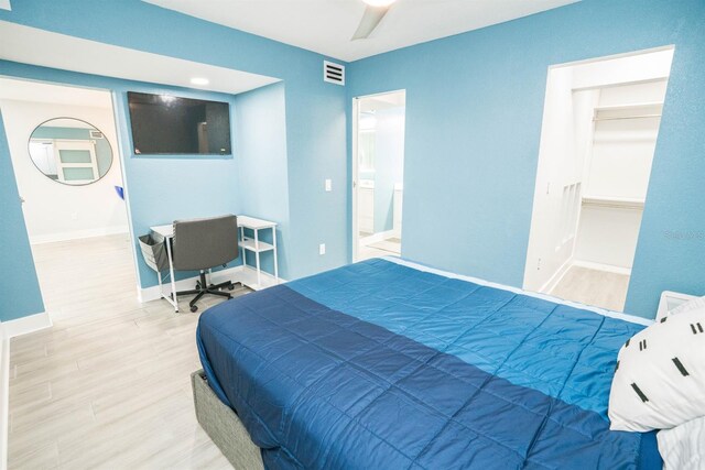 5712 Biscayne Ct Unit 201, New Port Richey, FL 34652 - bedroom with wood finished floors, baseboards, ceiling fan, and a spacious closet