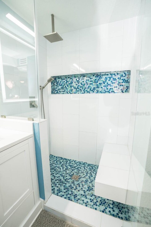 5712 Biscayne Ct Unit 201, New Port Richey, FL 34652 - bathroom featuring tiled shower and vanity