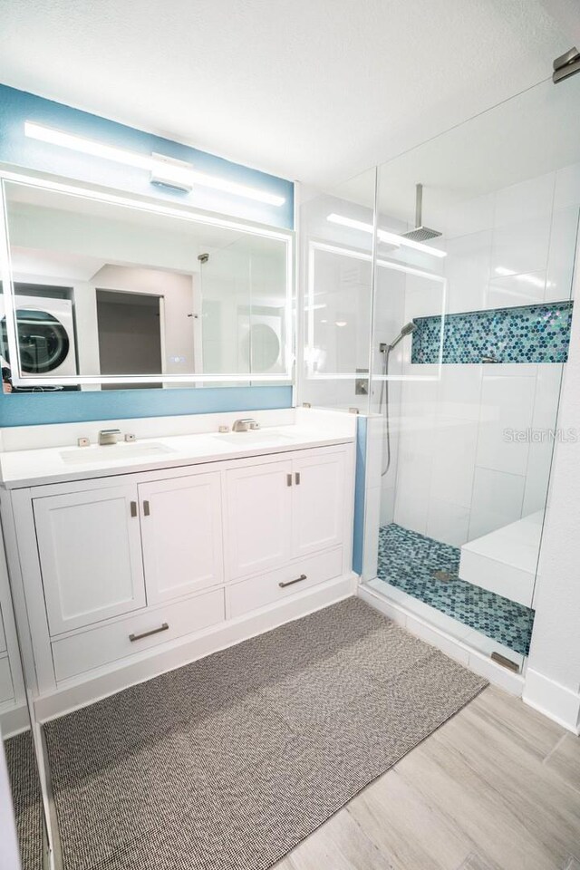 5712 Biscayne Ct Unit 201, New Port Richey, FL 34652 - bathroom featuring tiled shower, wood finished floors, and double vanity