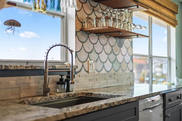 4137 Des Prez Ct, Hernando Beach, FL 34607 - kitchen featuring a sink, dishwashing machine, decorative backsplash, stone counters, and healthy amount of natural light