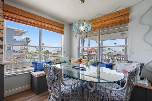 4137 Des Prez Ct, Hernando Beach, FL 34607 - dining area with a chandelier, healthy amount of natural light, wood finished floors, and baseboards