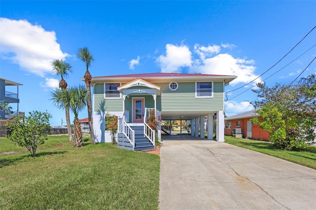 4137 Des Prez Ct, Hernando Beach, FL 34607 - view of front of home featuring a carport, driveway, a front yard, and stairs