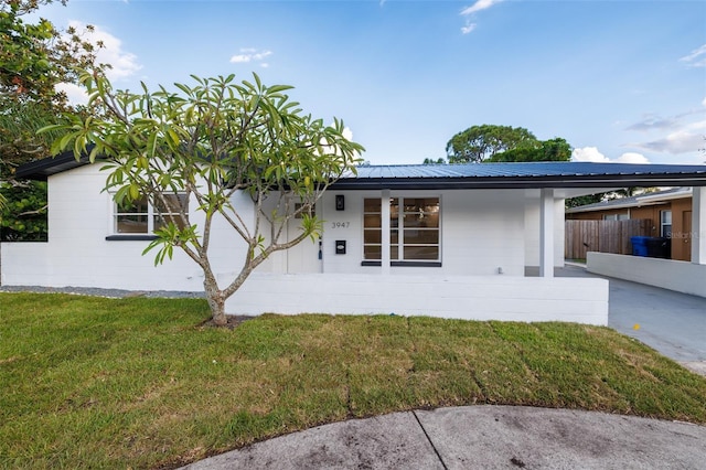 3947 Overlook Dr NE, Saint Petersburg, FL 33703 - view of front of home featuring metal roof and covered porch