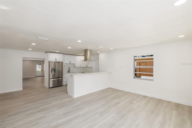 3947 Overlook Dr NE, Saint Petersburg, FL 33703 - kitchen with stainless steel refrigerator with ice dispenser, island range hood, a peninsula, light wood-style floors, and recessed lighting