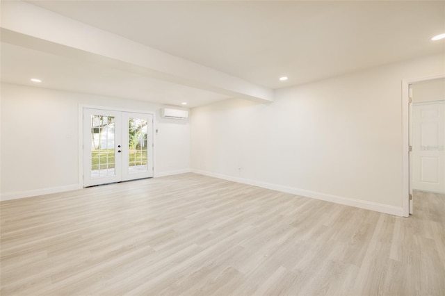 3947 Overlook Dr NE, Saint Petersburg, FL 33703 - unfurnished room with light wood finished floors, an AC wall unit, french doors, baseboards, and recessed lighting
