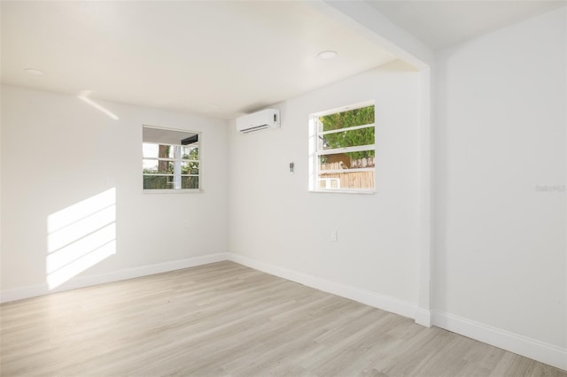 3947 Overlook Dr NE, Saint Petersburg, FL 33703 - spare room with a wall unit AC, light wood finished floors, baseboards, healthy amount of natural light, and recessed lighting