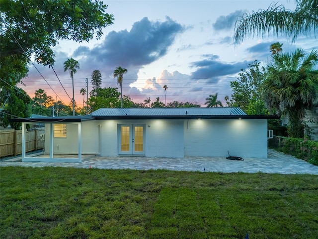 3947 Overlook Dr NE, Saint Petersburg, FL 33703 - back of house with french doors, a patio, and metal roof