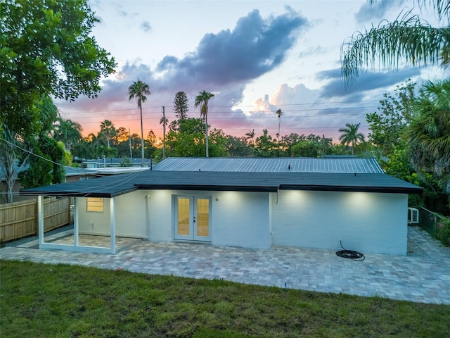 3947 Overlook Dr NE, Saint Petersburg, FL 33703 - back of house with french doors, a patio area, and metal roof