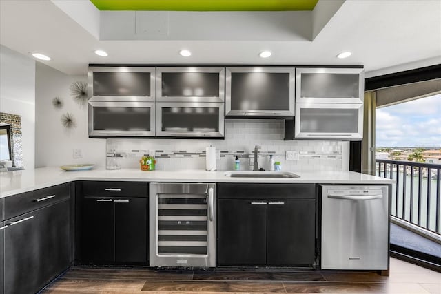 1651 Sand Key Estates Ct Unit 54, Clearwater Beach, FL 33767 - kitchen with beverage cooler, dishwasher, a sink, backsplash, and recessed lighting