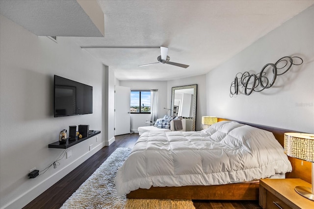1651 Sand Key Estates Ct Unit 54, Clearwater Beach, FL 33767 - bedroom featuring dark wood finished floors, baseboards, and a ceiling fan