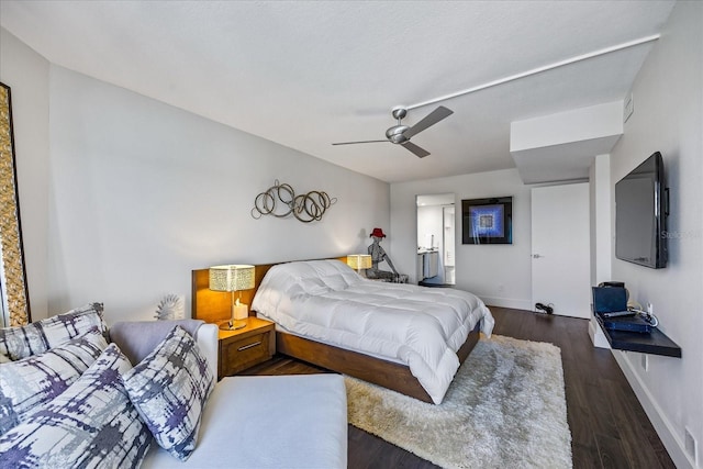 1651 Sand Key Estates Ct Unit 54, Clearwater Beach, FL 33767 - bedroom with baseboards, wood finished floors, and a ceiling fan