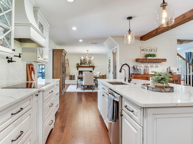 3724 Fawn Grove Ct, Land O Lakes, FL 34639 - kitchen with stainless steel dishwasher, a sink, premium range hood, white cabinetry, and black electric cooktop