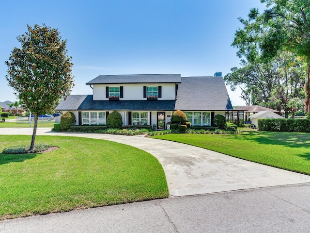 3724 Fawn Grove Ct, Land O Lakes, FL 34639 - traditional-style home with curved driveway and a front lawn