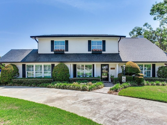 3724 Fawn Grove Ct, Land O Lakes, FL 34639 - traditional home featuring brick siding, a chimney, and a front yard